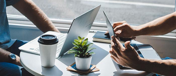 Two Professionals with a Laptop Showcasing Financial & Investment Planning Services in Bedford, NH